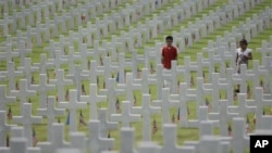 Children walk along layers of tombs as they attend Memorial Day ceremonies at the Manila American Cemtery and Memorial in suburban Taguig, south of Manila, Philippines on Sunday May 29, 2011. The cemetery site contains the largest number of U.S. military