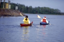 FILE - Canoe paddlers are seen in the Aland archipelago, Finland in the summer of 1997. The 6,500 sun splashed islands have been a treasured summer playground for generations of Finns and Swedes. (AP Photo/Tor Wennstrom,LEHTIKUVA)