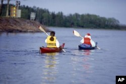 FILE - Canoe paddlers are seen in the Aland archipelago, Finland in the summer of 1997. The 6,500 sun splashed islands have been a treasured summer playground for generations of Finns and Swedes. (AP Photo/Tor Wennstrom,LEHTIKUVA)