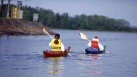 FILE - Canoe paddlers are seen in the Aland archipelago, Finland in the summer of 1997. The 6,500 sun splashed islands have been a treasured summer playground for generations of Finns and Swedes. (AP Photo/Tor Wennstrom,LEHTIKUVA)