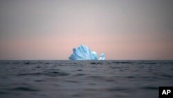In this Aug. 15, 2019, file photo, a large Iceberg floats away as the sun sets near Kulusuk, Greenland. (AP Photo/Felipe Dana, File)