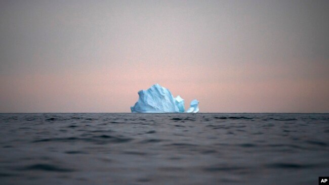In this Aug. 15, 2019, file photo, a large Iceberg floats away as the sun sets near Kulusuk, Greenland. (AP Photo/Felipe Dana, File)