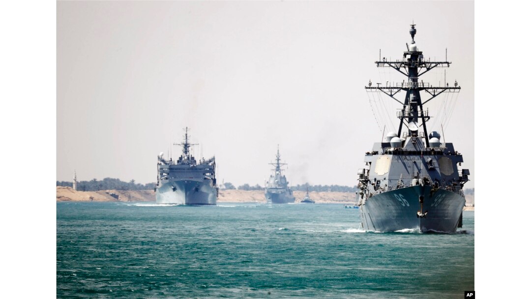 In this photo provided by the U.S. Navy, the Abraham Lincoln Carrier Strike Group transits the Suez Canal, May 9, 2019.