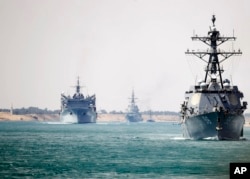 In this photo provided by the U.S. Navy, the Abraham Lincoln Carrier Strike Group transits the Suez Canal, May 9, 2019.