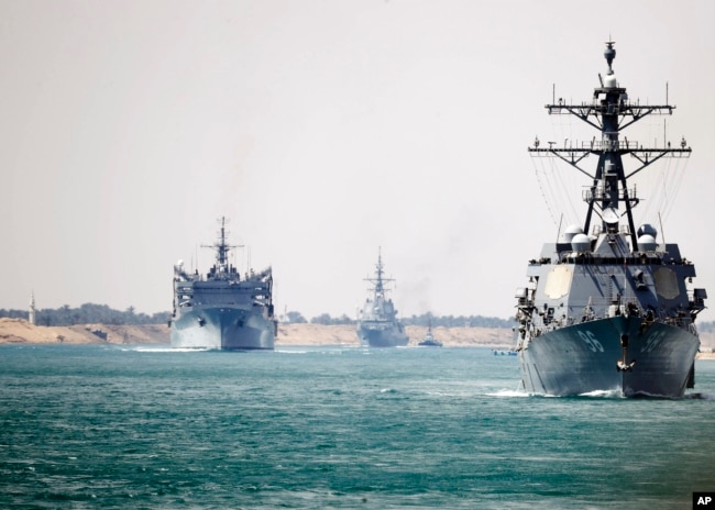 In this photo provided by the U.S. Navy, the Abraham Lincoln Carrier Strike Group transits the Suez Canal, May 9, 2019.
