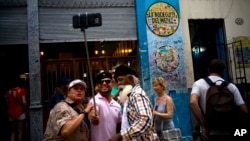 FILE - Tourists take a selfie at the Bodeguita del Medio bar in Havana, Cuba, April 28, 2017.
