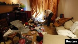 A journalist films the apartment of opposition leader and anti-corruption blogger Alexei Navalny after it was searched by police in Moscow