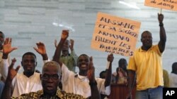 People protest against the European Union in Abidjan, and Ivory Coast cocoa exporters said they feared for their future after presidential claimant Alassane Ouattara said he would extend one-month cocoa export ban if his rival refuses to leave power, Febr