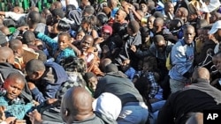Thousands of young students and their parents push their way into the gates causing a stampede at the University of Johannesburg, South Africa on Jan. 10, 2012. One person died and two others were seriously injured, officials said.