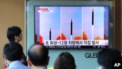 People watch a TV screen showing a local news program reporting about North Korea's missile launch, at the Seoul Railway Station in Seoul, South Korea, Saturday, Sept. 16, 2017.