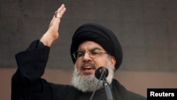 Lebanon's Hezbollah leader Sayyed Hassan Nasrallah addresses his supporters during a religious procession to mark Ashura in Beirut's suburbs, Nov. 14, 2013. 
