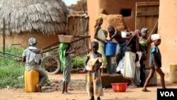 Children gather water in Bagega, Nigeria, where thousands have been exposed to lead poisoning, Oct. 2012. (H. Murdock for VOA)