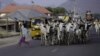 FILE - A boy runs as a herd of cattle approach on a street in Jalingo, Apr. 10, 2015. 