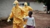 Health workers accompany a nine-year-old who contracted the Ebola virus to a Monrovia treatment center, Sept. 30, 2014.