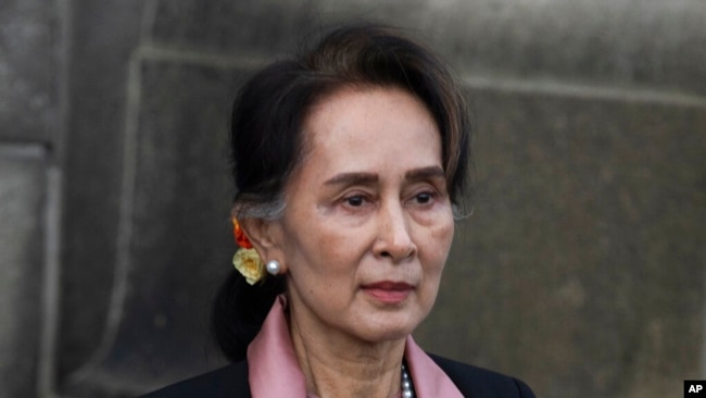 FILE - Myanmar's Aung San Suu Kyi leaves the International Criminal Court after the first of three days of hearings in The Hague, the Netherlands, Dec. 10, 2019.