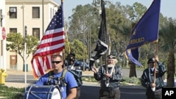 Troy Yocum, accompanied by other veterans, enters Los Angeles