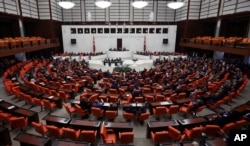 Members of the parliament vote during an extraordinary session in Ankara, Turkey, Sept. 23, 2017.