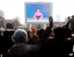 North Koreans watch a news broadcast on a video screen outside Pyongyang Railway Station in Pyongyang, North Korea, Wednesday, Jan. 6, 2016.