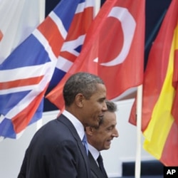 U.S. President Barack Obama (L) walks with French President Nicholas Sarkozy, after Obama's arrival at Espace Riviera for the G20 summit in Cannes, France, November 3, 2011.