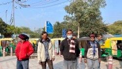 A group of autorickshaw drivers wait outside a metro station in New Delhi for passengers. (Anjana Pasricha/VOA)