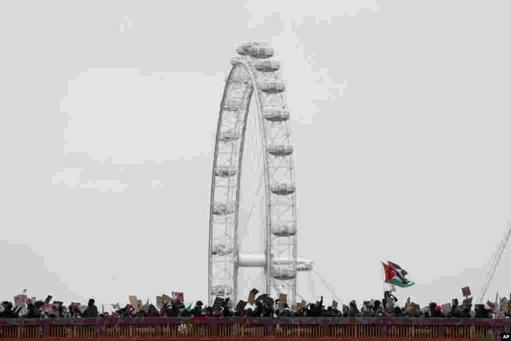 Protesters march across the Vauxhall bridge during the Black Lives Matter protest rally in London.