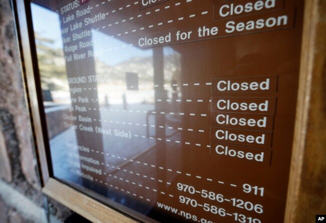A sign inside the main visitors center notes that campgrounds are closed at Rocky Mountain National Park, Dec. 22, 2018, in Estes Park, Colo., because of a partial federal shutdown.