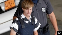 FILE - Charleston, S.C., shooting suspect Dylann Roof is escorted from the Cleveland County Courthouse in Shelby, N.C., June 18, 2015.