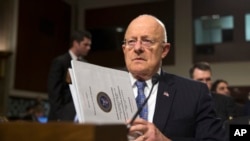 Director of National Intelligence James Clapper prepares to testify on Capitol Hill in Washington, Tuesday, Feb. 9, 2016, before a Senate Armed Services hearing on worldwide threats. (AP Photo/Evan Vucci)