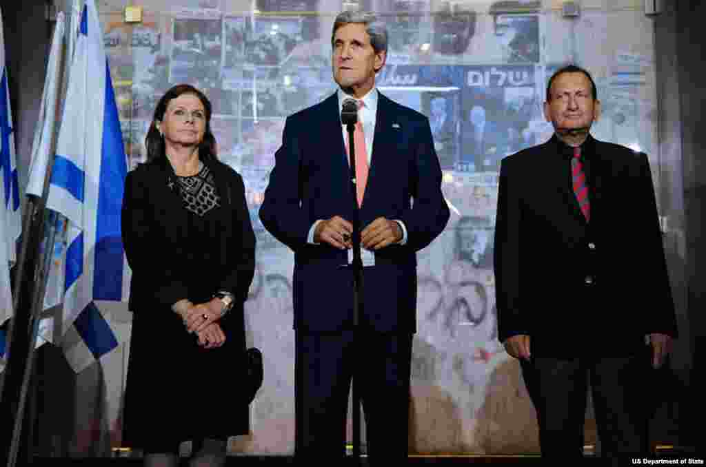 U.S. Secretary of State John Kerry, flanked by Yitzhak Rabin's daughter Dalia and Tel Aviv Mayor Ron Huldai, speaks after laying a wreath at the site where the former Israeli Prime Minister was assassinated in 1995, during a stop in Tel Aviv, Israel, on N