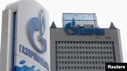 FILE - A general view shows the headquarters of Gazprom, with a board of Gazprom Neft, the oil arm of Gazprom seen in the foreground, in Moscow. 