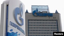 FILE - A general view shows the headquarters of Gazprom, with a board of Gazprom Neft, the oil arm of Gazprom seen in the foreground, on the day of the annual general meeting of the company's shareholders in Moscow. 