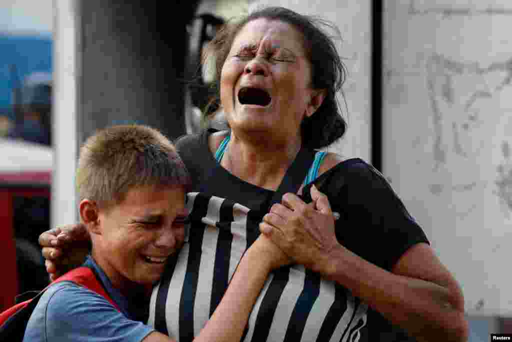 Relatives of inmates cry at the General Command of the Carabobo Police as they wait outside the prison, where a fire occurred in the cells area, according to local media, in Valencia, Venezuela, March 28, 2018. Rioting and a fire in the cells of a police station in the central city killed 68 people, according to the government and witnesses.