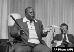 FILE: Joshua Nkomo, co-leader of the Patriotic Front, tells newsmen that the Kissinger plan "does not exist," in Geneva, Switzerland, Dec. 9, 1976. "We cannot have the so-called Anglo-American plan imposed on the people of Zimbabwe," he said.