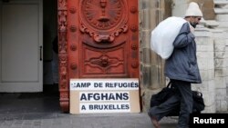 FILE - An Afghan asylum seeker walks out a church in central Brussels January 30, 2014.