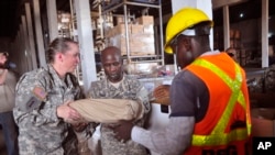 American soldiers sort through Ebola virus protection equipment to be used in Ebola clinics across the country in Monrovia, Liberia. (File photo)