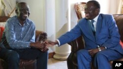 Zimbabwean President Emmerson Mnangagwa, right, talks to Morgan Tsvangirai, the main opposition leader in Zimbabwe, during a visit to his residence in Harare, Jan. 5, 2018.