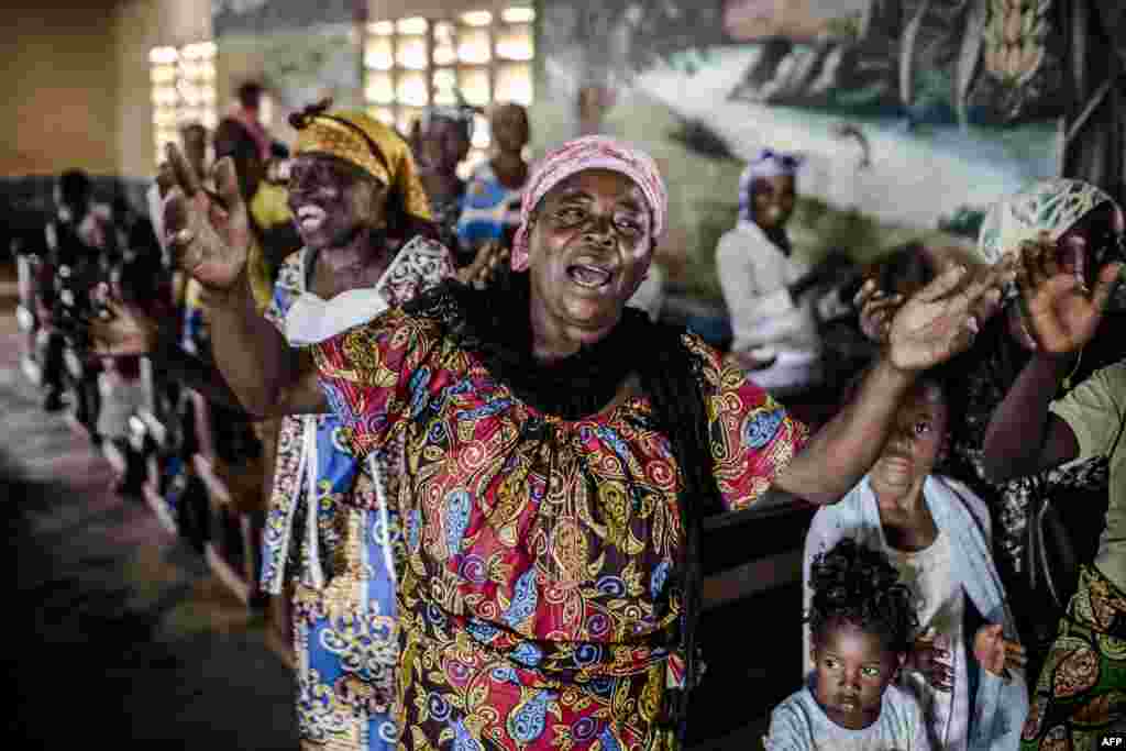 A worshiper prays and sings during a Christmas service in the Baptist Community of the Congo River in Loma, near Mbanza-Ngungu, Democratic Republic of Congo, during the Christian holiday of Christmas.