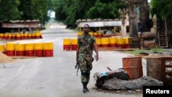 FILE - A soldier walks past a checkpoint in Bama, Borno State, Nigeria, Aug. 31, 2016. 