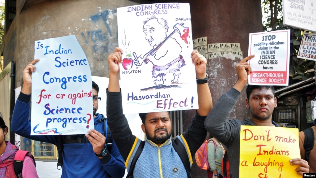 People hold placards to protest claims made by speakers, discrediting theories of Isaac Newton and Albert Einstein, at the 106th Indian Science Congress in Kolkata, India, Jan. 7, 2019.