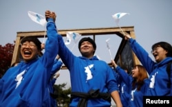 People wave the Korean unification flag during the inter-Korean summit, near the demilitarized zone separating the two Koreas, in Paju, South Korea, April 27, 2018.