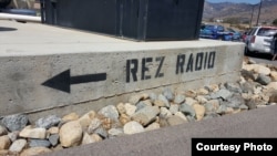 Photo shows painted curb in parking lot of the Pala Band of Mission Indians' Pala Rez Radio 91.3 in Pala, California.