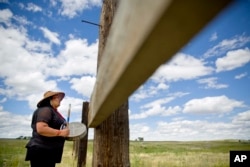 FILE - Roxanne White, whose aunt was murdered in 1996, sings and drums a women's warrior and honor song created for missing and murdered indigenous women, before joining a search in Valier, Mont., for Ashley HeavyRunner Loring.