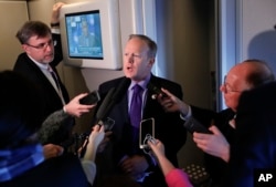 White House press secretary Sean Spicer speaks to reporters on Air Force One en route to Andrews Air Force Base from Philadelphia, Jan. 26, 2017. Spicer says that taxing imports from Mexico would generate $10 billion a year and "easily pay for the wall."