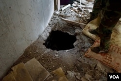 An entrance is shown to a network of honey-combing tunnels underneath Bashiqa, Iraq, Nov. 8, 2016. (J. Dettmer/VOA).