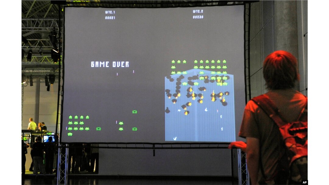 A visitor plays an adaption of the historic computer game 'Space Invaders' at the Games Convention in Leipzig, Germany, Aug. 20, 2008.