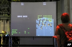 A visitor plays an adaption of the historic computer game 'Space Invaders' at the Games Convention in Leipzig, Germany, Aug. 20, 2008.