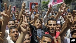 Anti-government protesters shout slogans during a demonstration demanding the ouster of Yemen's President Ali Abdullah Saleh, in the southern city of Taiz April 12, 2011