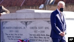 President Joe Biden walks away after a wreath laying at the tomb of the Rev. Martin Luther King Jr., and his wife, Coretta Scott King, Jan. 11, 2022, in Atlanta, Georgia.