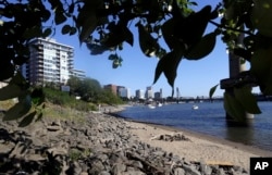 In this Thursday, July 6, 2017 photo, a section of a newly formed beach, named Poet's Beach, is shown on the Willamette River in downtown Portland, Oregon.