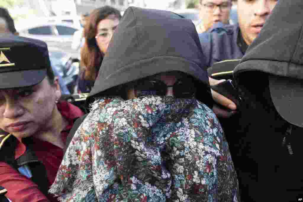 Former first lady and former presidential candidate Sandra Torres is escorted by police to the Supreme Court in Guatemala City. Authorities arrested Torres at her home on charges of campaign finance violations.